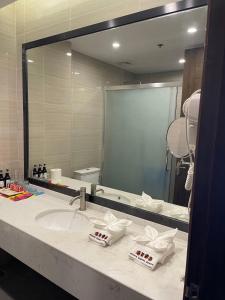 a bathroom with a sink and a large mirror at El Nido Garden Resort in El Nido