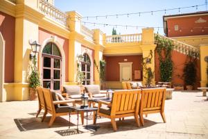 a patio with chairs and tables in front of a building at Hotel Viata in Austin