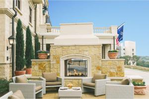a patio with chairs and a fireplace in front of a building at Hotel Viata in Austin