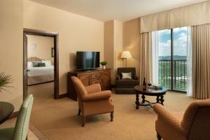 a hotel room with a room with a bed and a television at Hotel Viata in Austin