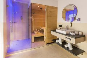 un bagno con doccia e lavandino di Hotel Hennersberg a Wörgl