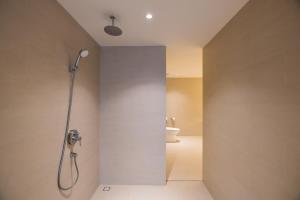 a bathroom with a shower and a toilet at Ana Anan Resort & Villas Pattaya in Na Jomtien