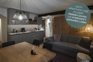 a living room with a couch and a table at Apartments Koflhaus in Cadipietra