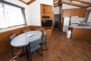 a kitchen with a table and chairs in a room at BIG4 Robe Lakeside Tourist Park in Robe