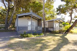 a couple of blue mobile homes in a park at BIG4 Robe Lakeside Tourist Park in Robe +10 photos