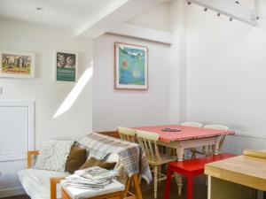 a dining room with a table and a couch at St James Cottage in Shaftesbury