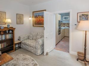 a living room with a couch and a chair at The Nook At Henge Estate in Shrewton