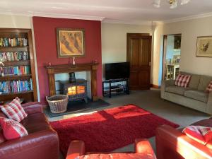 a living room with a couch and a fireplace at Westlin in Penpont