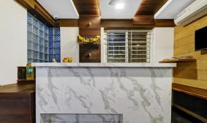a kitchen with a large marble counter top at Treebo Trend Elite Heritage in Bangalore
