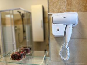 a phone is hanging on a wall in a bathroom at Martina Serravalle Scrivia 48 in Serravalle Scrivia