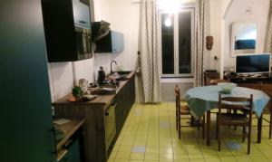 a kitchen with a table and a dining room at Maison accueillante à Reillanne avec jardin clos in Reillanne +9 photos