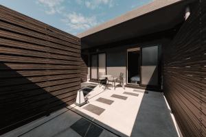 a balcony of a house with a black wall at ORI Rokkaku in Kyoto