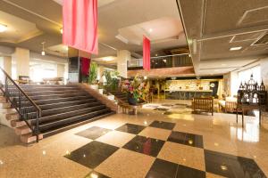 a lobby with a checkerboard floor and stairs in a building at Wano Resort Hazu in Gamagori