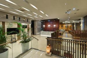 a lobby of a building with chairs and plants at Hotel Atrium Jongno in Seoul