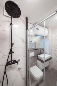 a bathroom with a glass shower with a toilet at Apartman Pesic in Pirot