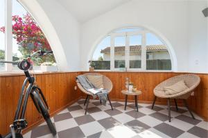 a room with two chairs and a table and two windows at Casa Bahía de Alcudia in Port d'Alcudia