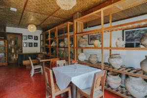 a dining room with a table and some vases on shelves at Alam Bidadari Seminyak in Seminyak