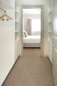 a bedroom with a bed and a closet at Centrepoint Apartments Griffith in Griffith
