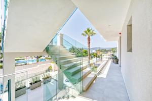 a view from the balcony of a building with glass stairs at Hidden Cove Corfu in Kontokali