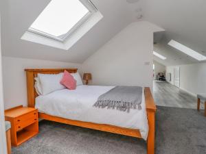 a bedroom with a bed and a skylight at Sea La Vie in Lytham St Annes