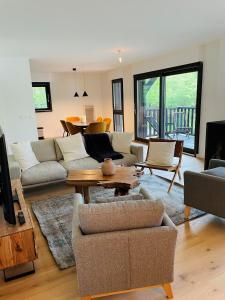 a living room with a couch and a table at Résidence-Chalet de Prestige Aspen Park - 103 in Auron