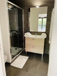 a bathroom with a sink and a shower and a mirror at Résidence-Chalet de Prestige Aspen Park - 103 in Auron