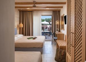 a hotel room with two beds and a table at Kseynasa Suites in Nikiti +157 photos