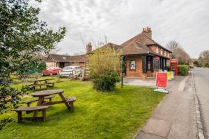 a couple of picnic tables in front of a building at Modern Elegant Luxury 1 bed flat Free parking 