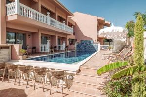 a villa with a swimming pool and a patio at Kseynasa Suites in Nikiti