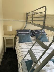 a bedroom with a bunk bed with blue pillows at Clarkes 1st floor Apartment Leslie- Golf Paradies in Leslie