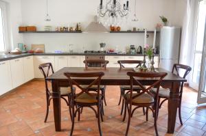 cocina con mesa, sillas y nevera en Lovely Cecilia, en San Siro