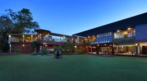 a large building with a green lawn in front of it at Alindra Villas & Spa in Nusa Dua