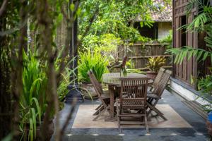 a table and chairs sitting on a patio at Yabbiekayu Eco-Bungalows in Yogyakarta