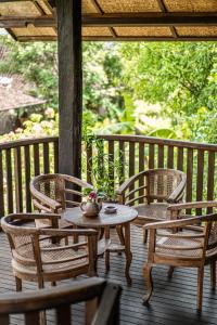 two chairs and a table on a porch at Yabbiekayu Eco-Bungalows in Yogyakarta