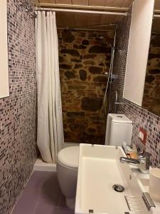 a bathroom with a white toilet and a sink at La Conchiglia in Scarlino