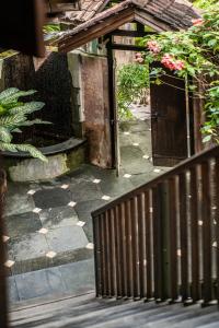 an entrance to a garden with a fence and flowers at Yabbiekayu Eco-Bungalows in Yogyakarta
