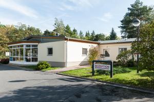 a building with a sign in front of it at Sportpension Dresden in Dresden