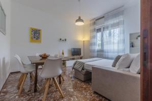 a bedroom with a bed and a table and chairs at Ferrara Charming apt 4 min walk from the bus stop! in Ferrara