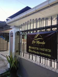 a sign on the side of a building at De'Manda Homestay in Sandakan