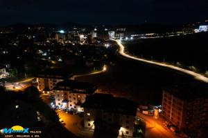 a view of a city at night with lights at Monix Palace Zlatibor in Zlatibor