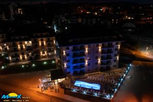 a building with a blue light on it at night at Monix Palace Zlatibor in Zlatibor