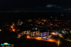a view of a city at night with lights at Monix Palace Zlatibor in Zlatibor