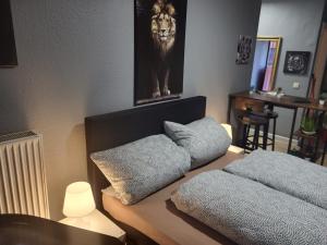 a room with two pillows on a table with a lion picture at Stadtnah an der Förde 116 in Flensburg