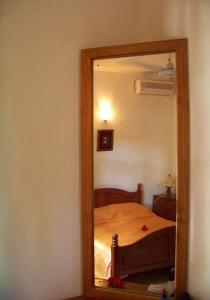a mirror in a room with a bed in it at Chalets Anse Possession in Baie Sainte Anne