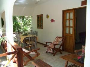 a living room with a table and chairs and a dining room at Chalets Anse Possession in Baie Sainte Anne