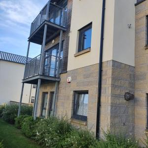 a building with a balcony on the side of it at 2-bedroom Back Hilton Area apartment - Ground Floor, Aberdeen city center in Aberdeen