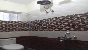 a bathroom with a sink and a toilet in a room at PPH Living Royal Pride in Madurai