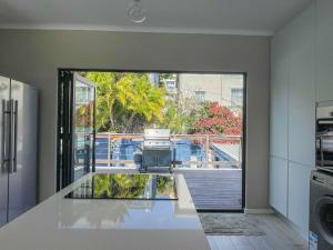 a kitchen with a view of a balcony at UysTUYS in Cape Town