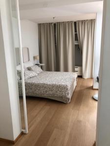a bedroom with a bed and a mirror at Joey in Pietrasanta