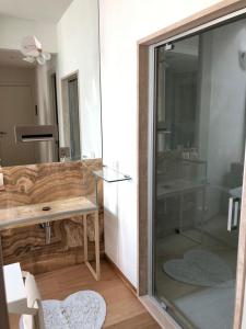 a bathroom with a glass shower and a sink at Joey in Pietrasanta